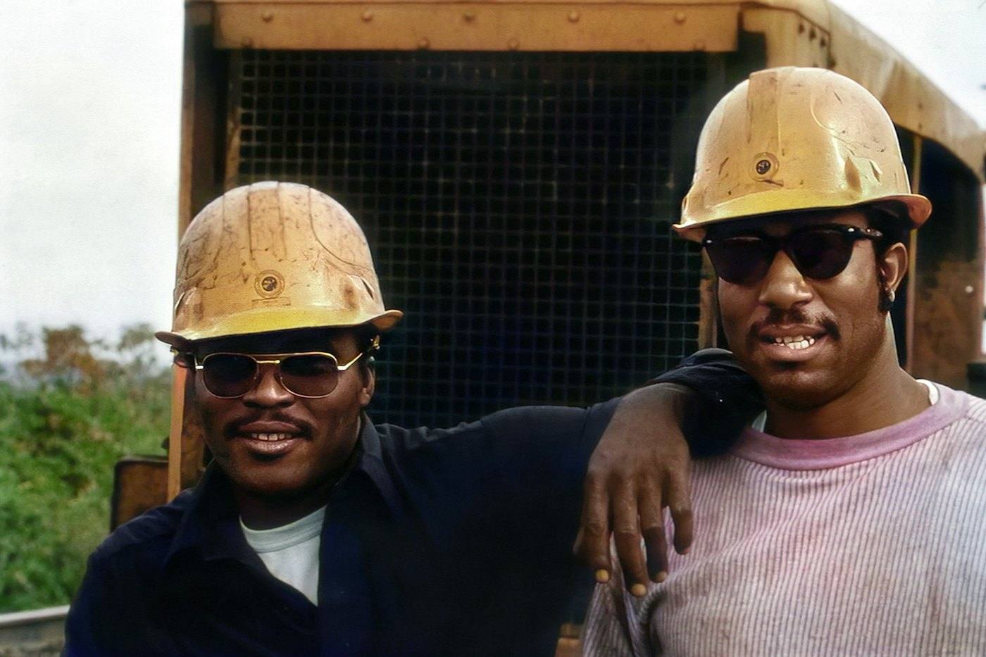 Two field technicians wearing hard hats
